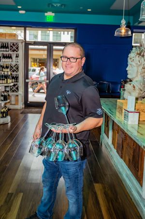 A sequence of photos showing someone carrying multiple beer glasses at a bar counter using the traditional German beer-holding technique.