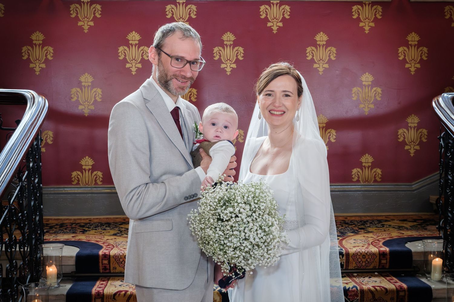 Couple in gray suit and white wedding dress share romantic moments during their wedding celebration.