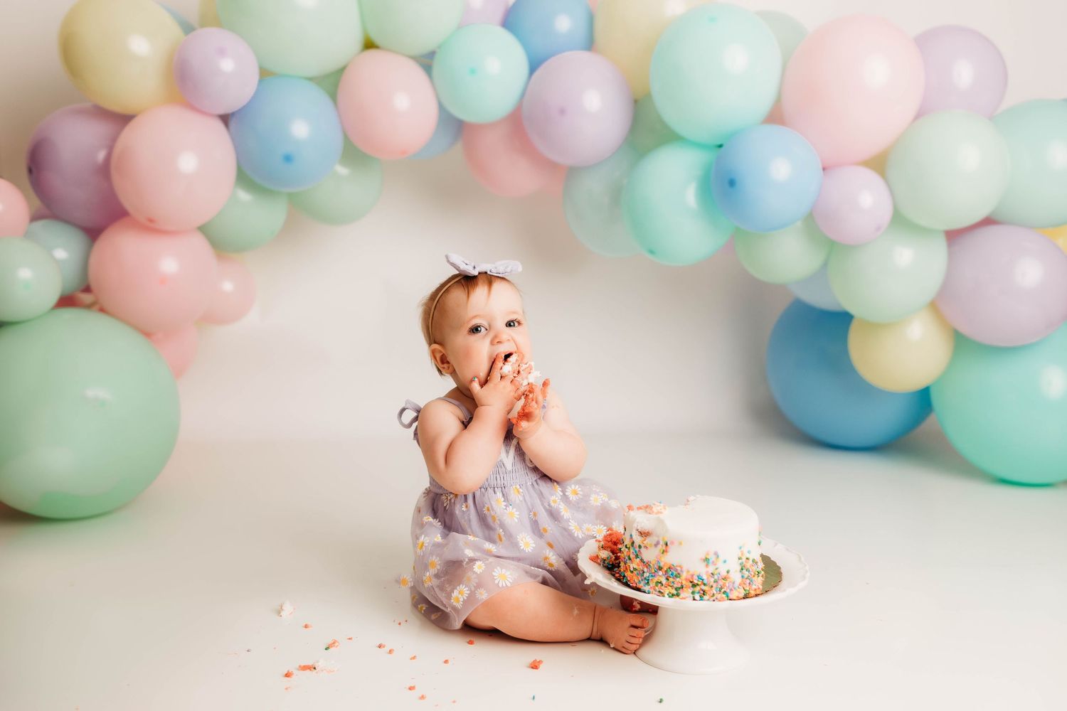 A sequence of lifestyle photos showing playful moments on a white couch with a round jute rug on hardwood floors.