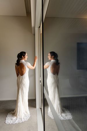 A sequence of dance movements in a white lace dress shown through multiple frames against a minimalist interior space.