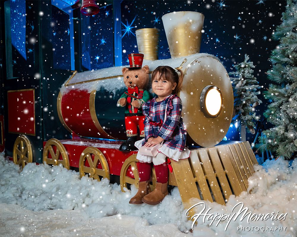 Snowy winter scene with wooden props and Christmas decorations for photo sessions.