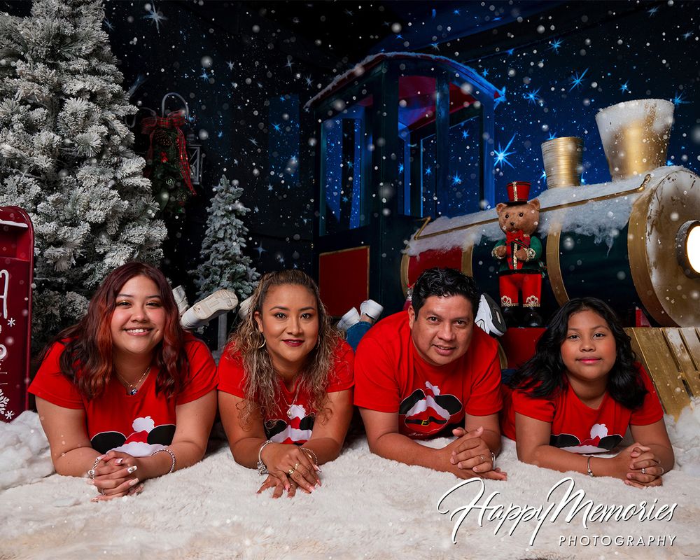 Holiday photo session with snowy ground and festive winter backdrop.