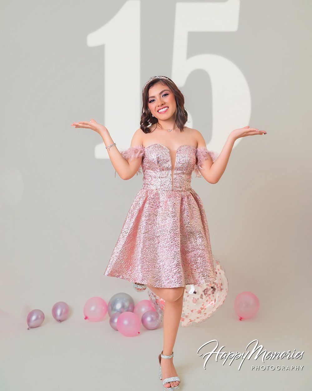 Birthday photoshoot featuring a shimmering pink dress and silver number fifteen balloons.