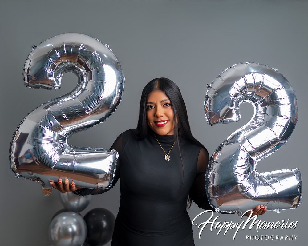 Portrait with silver number 22 mylar balloons and black mesh top for birthday celebration.