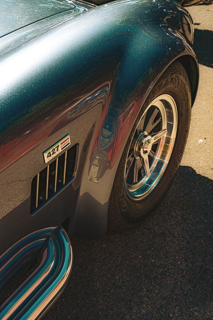 Close-up series showing custom striped pinstriping details and bodywork on a classic black vehicle.