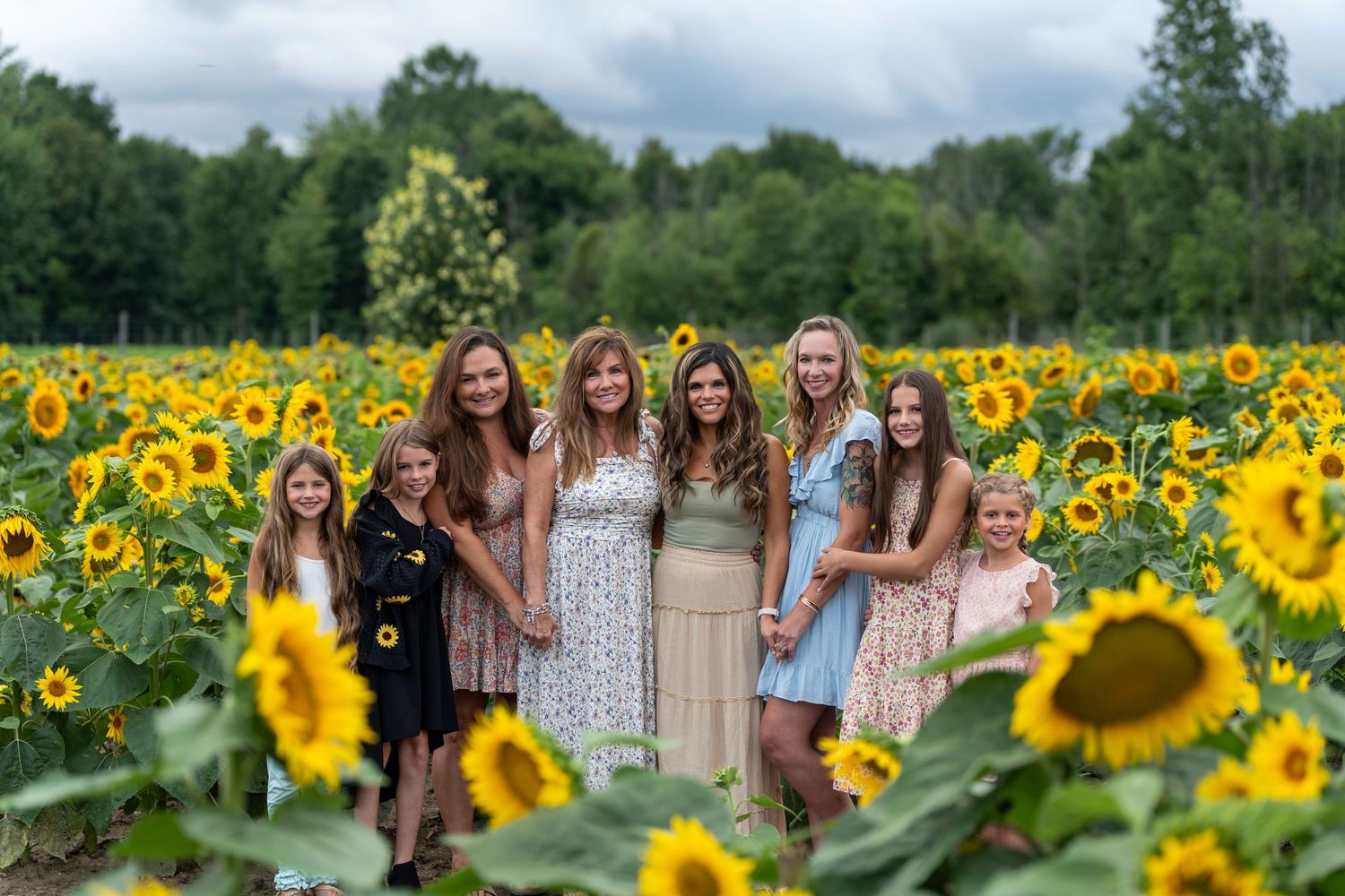 Large family group posed together on stone steps outdoors.