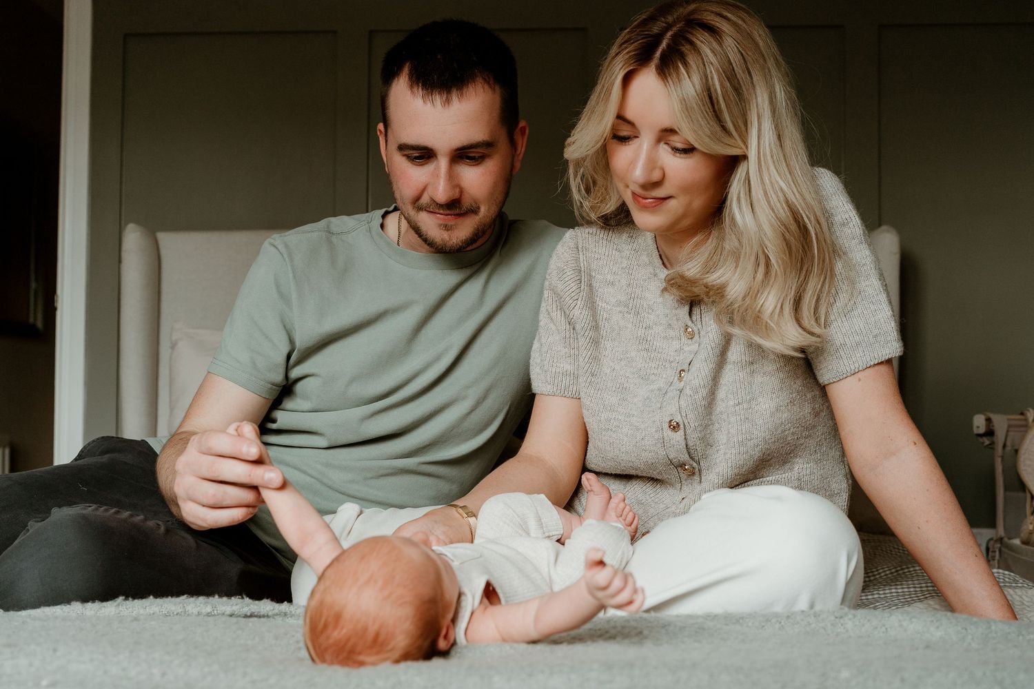 Casual lifestyle photoshoot of family relaxing together on bed.