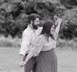 Black and white series of couple embracing in an outdoor setting.
