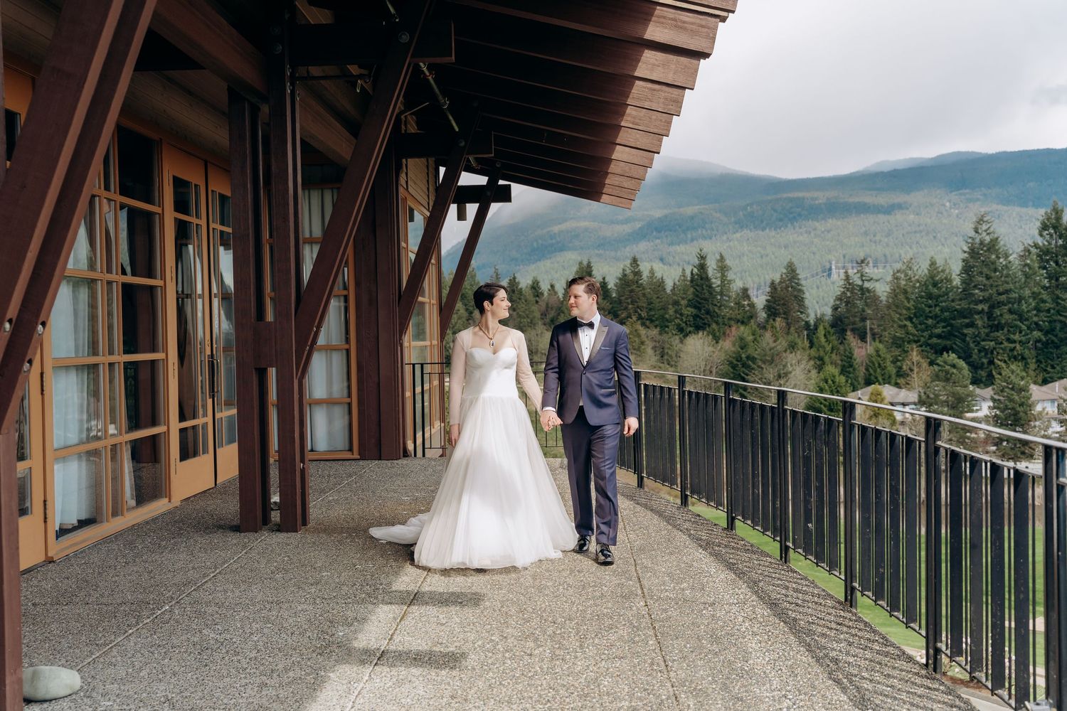 Panoramic view of a mountain lodge wedding ceremony with scenic forest backdrop.