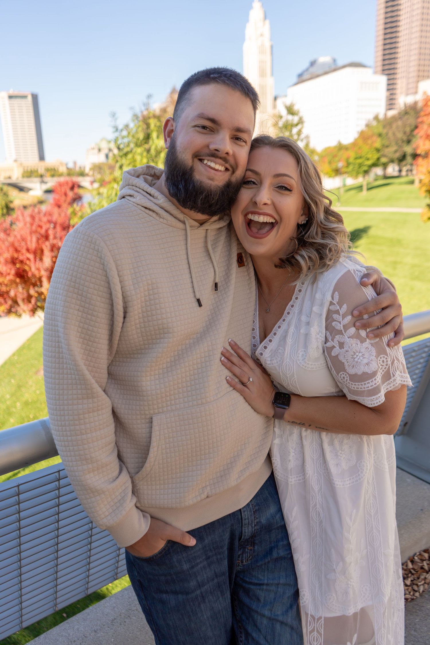 A couple sharing joyful moments together outdoors during autumn.