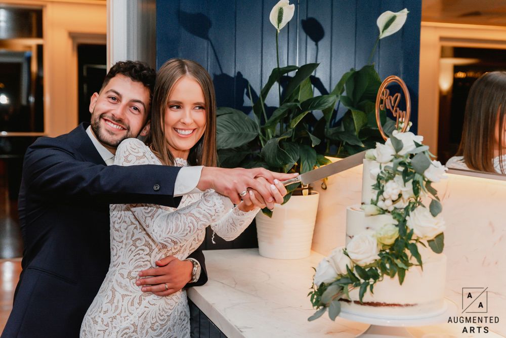 A romantic wedding celebration featuring a couple in formal attire sharing intimate moments among elegant indoor decor.