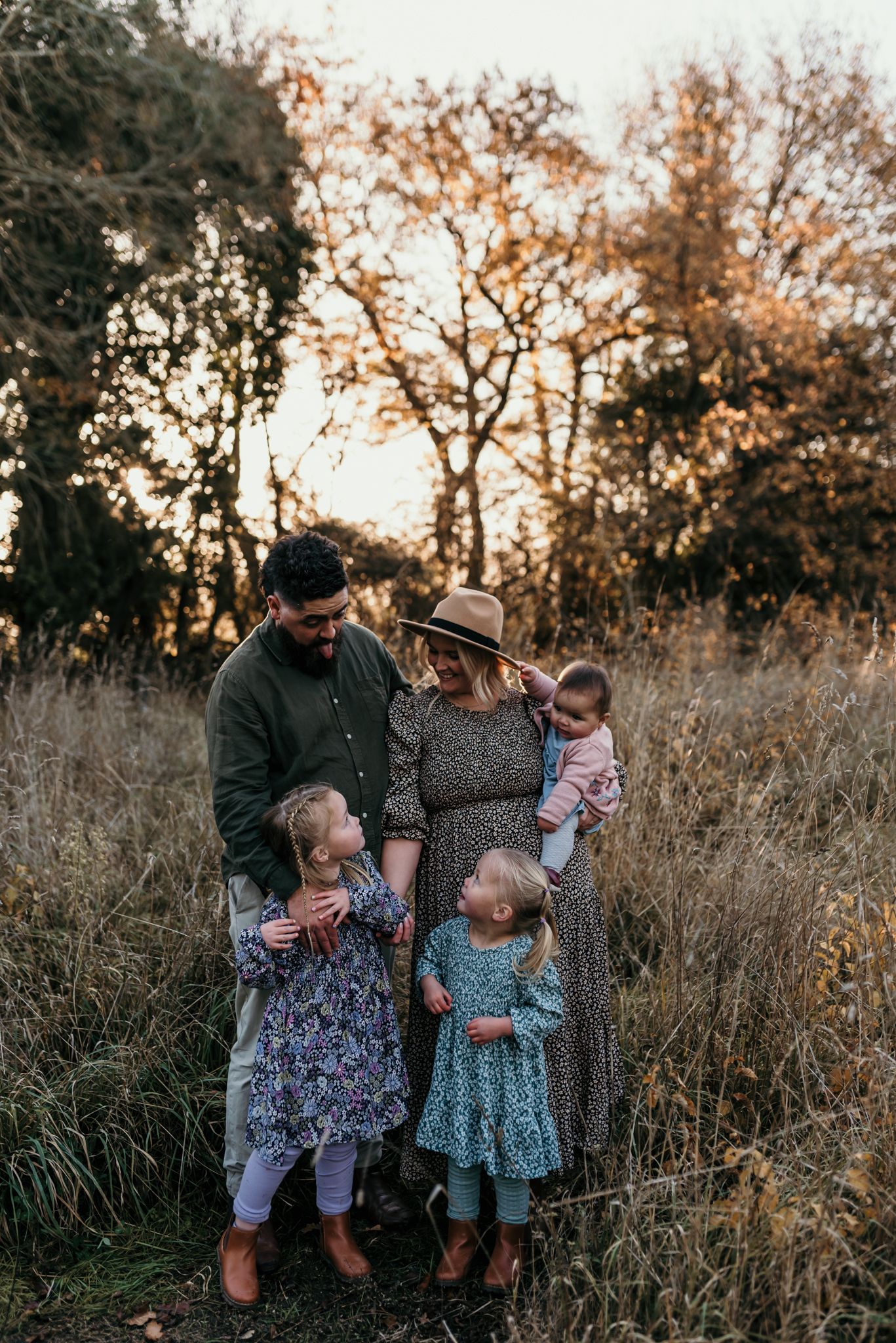 Family enjoying autumn weather together in a field at golden hour in Christchurch.