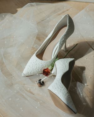 White lace wedding shoes with floral details arranged in a sequence of artistic detail shots.