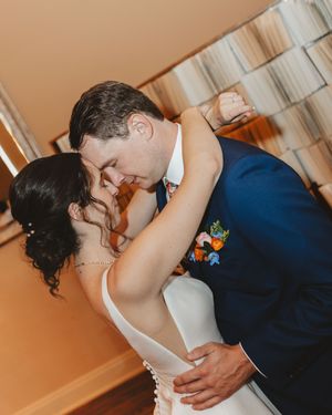 Romantic wedding couple sharing an intimate dance moment in formal attire.