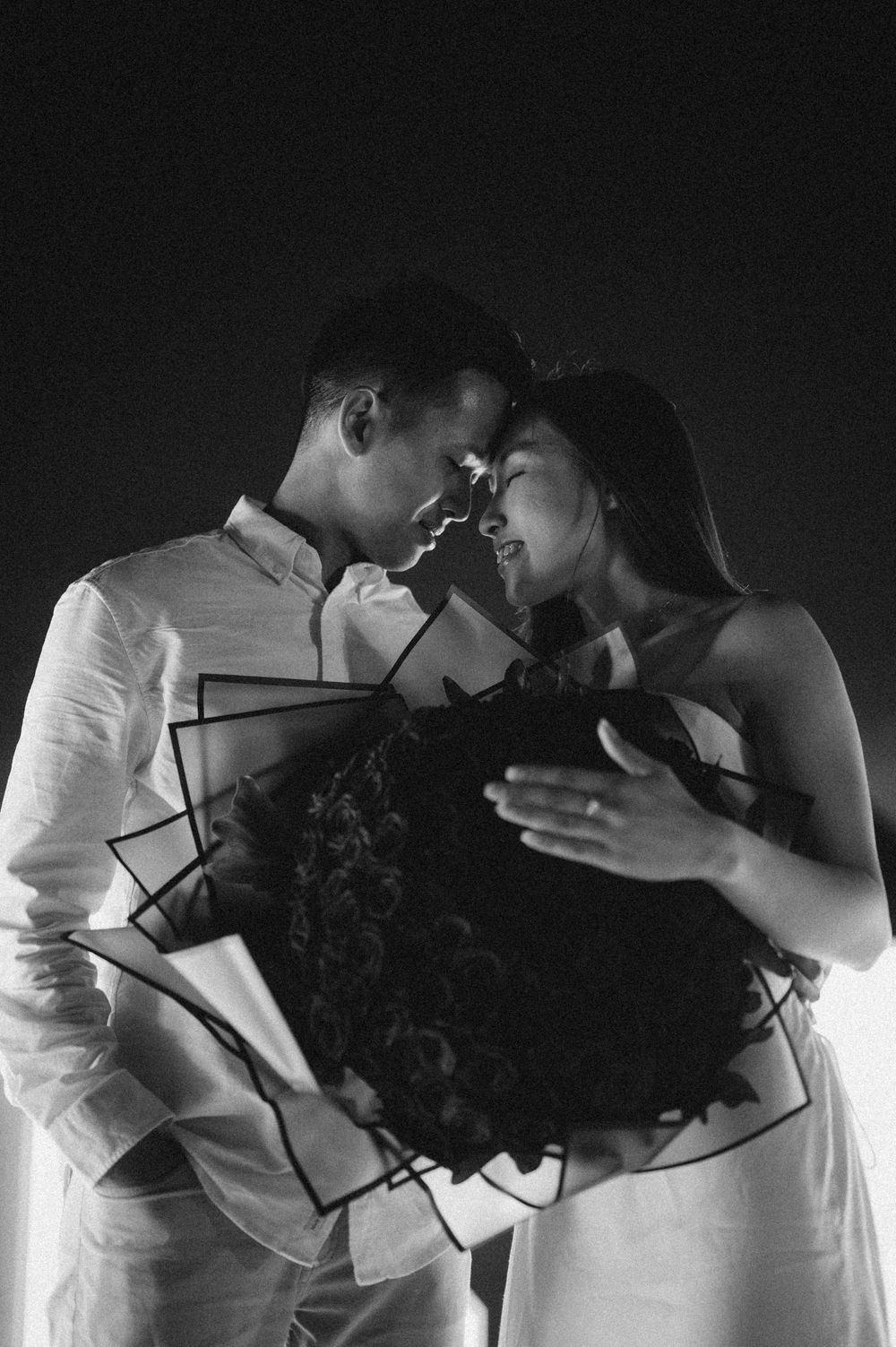 Artistic black and white silhouettes showing tender romantic moments between a couple.