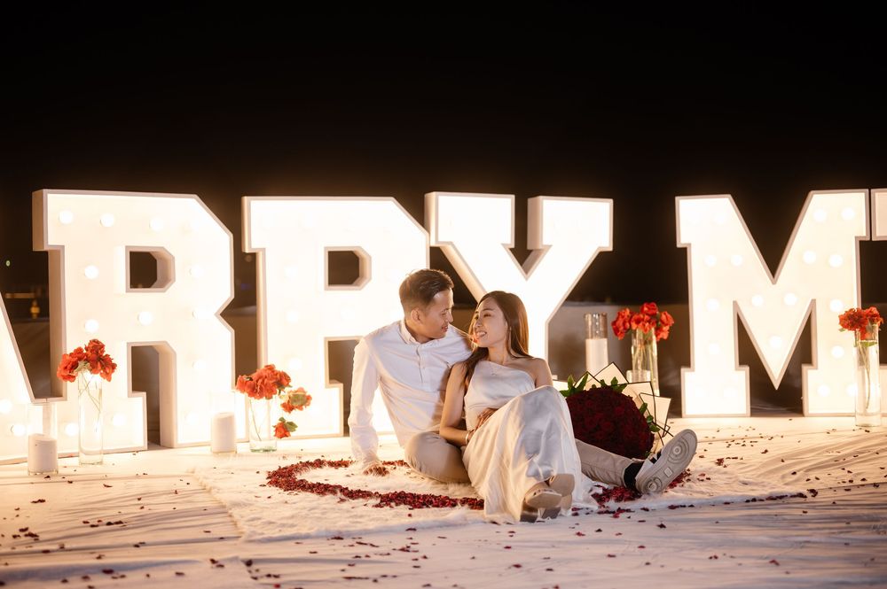 A Christmas decoration display spells out 'MERRY' in illuminated letters against a dark background.