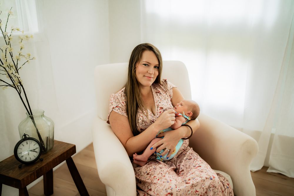 A series of photos showing someone sitting on a white couch while bottle feeding an infant in a bright room.