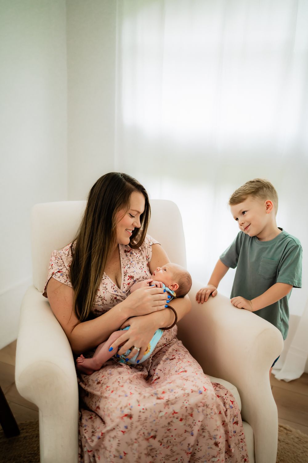 Three connected photos show tender moments of a family relaxing together on a light colored sofa in a bright room.