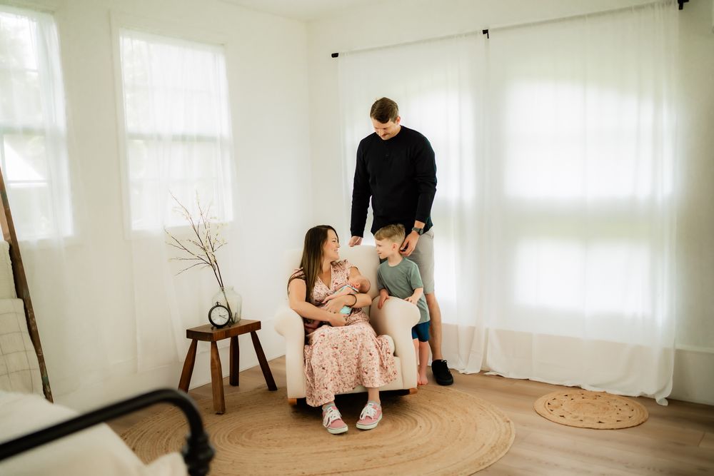 A sequence frame captures intimate moments of a couple in an all-white minimalist room with natural light.