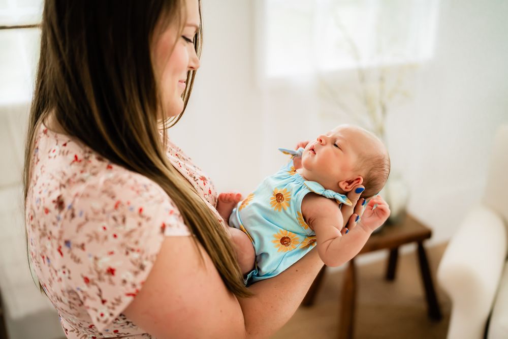 A tender moment captured between caregiver and infant in soft natural lighting through a series of connected images.