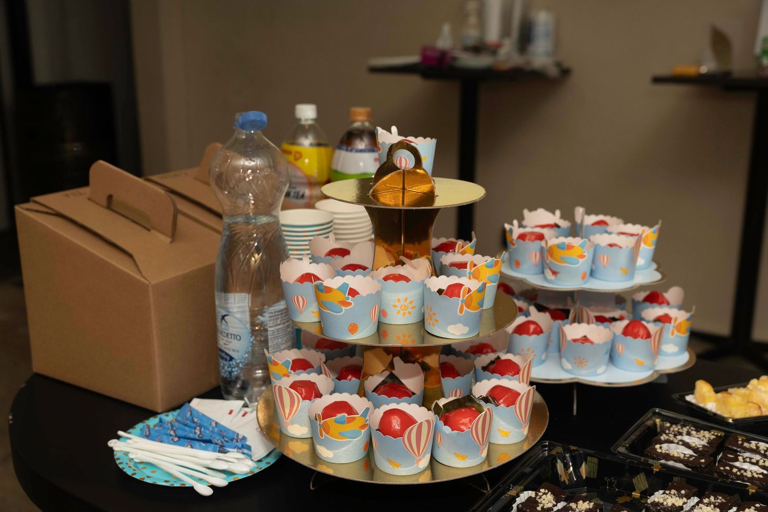A display of In-N-Out burger merchandise including shirts, cups, and other souvenirs lined up in an indoor setting.
