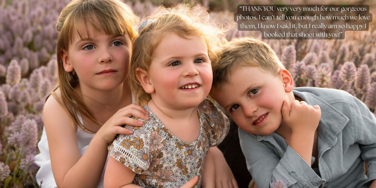 Three children pose together outdoors in a field of lavender flowers at sunset.