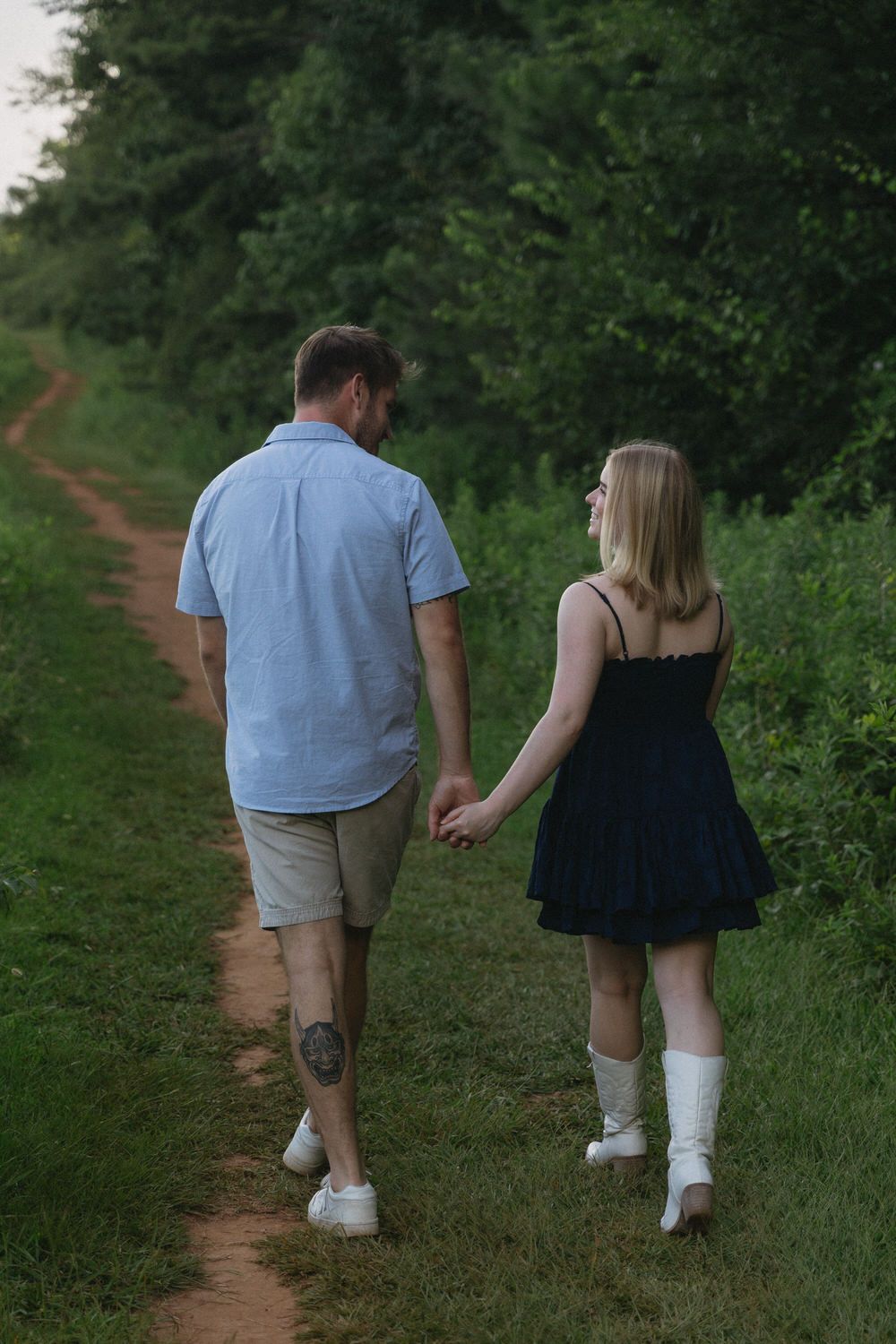 Couple laughing during a candid summer photoshoot in Blue Ridge, Georgia.