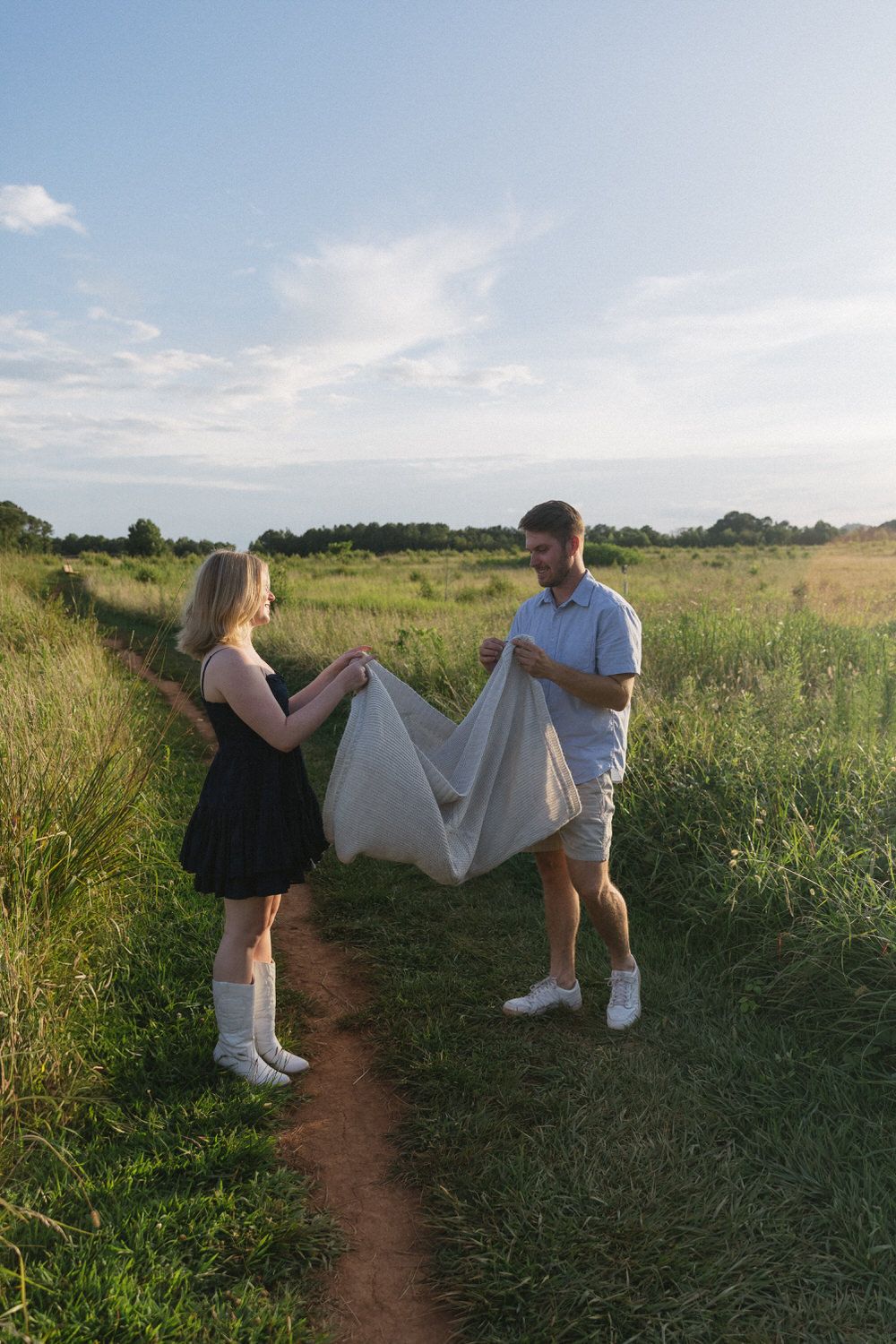 Couple sharing laughter during a warm July evening photoshoot.