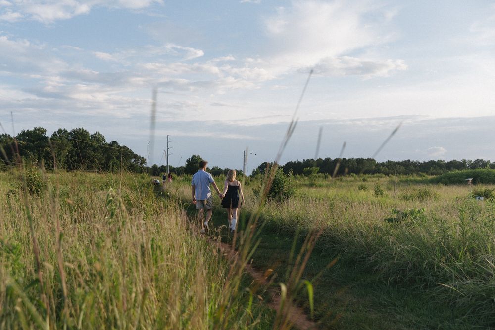 Couple walking hand in hand during a Blue Ridge mountain session.