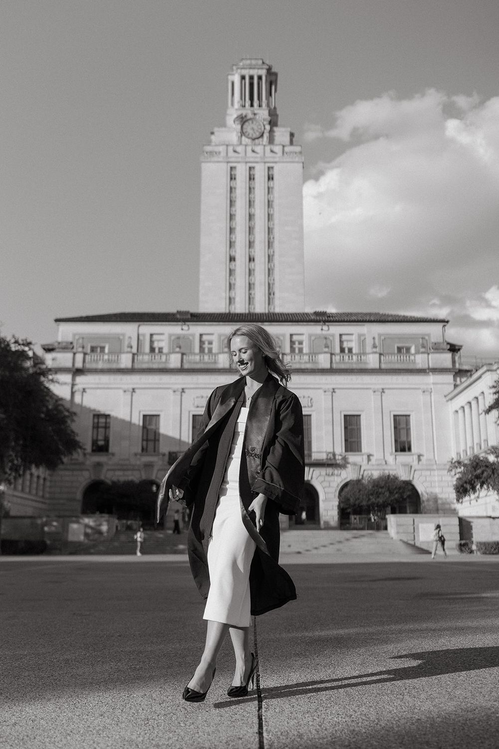 Black and white photo of the iconic University of Texas Tower with elegant architecture against cloudy sky.
