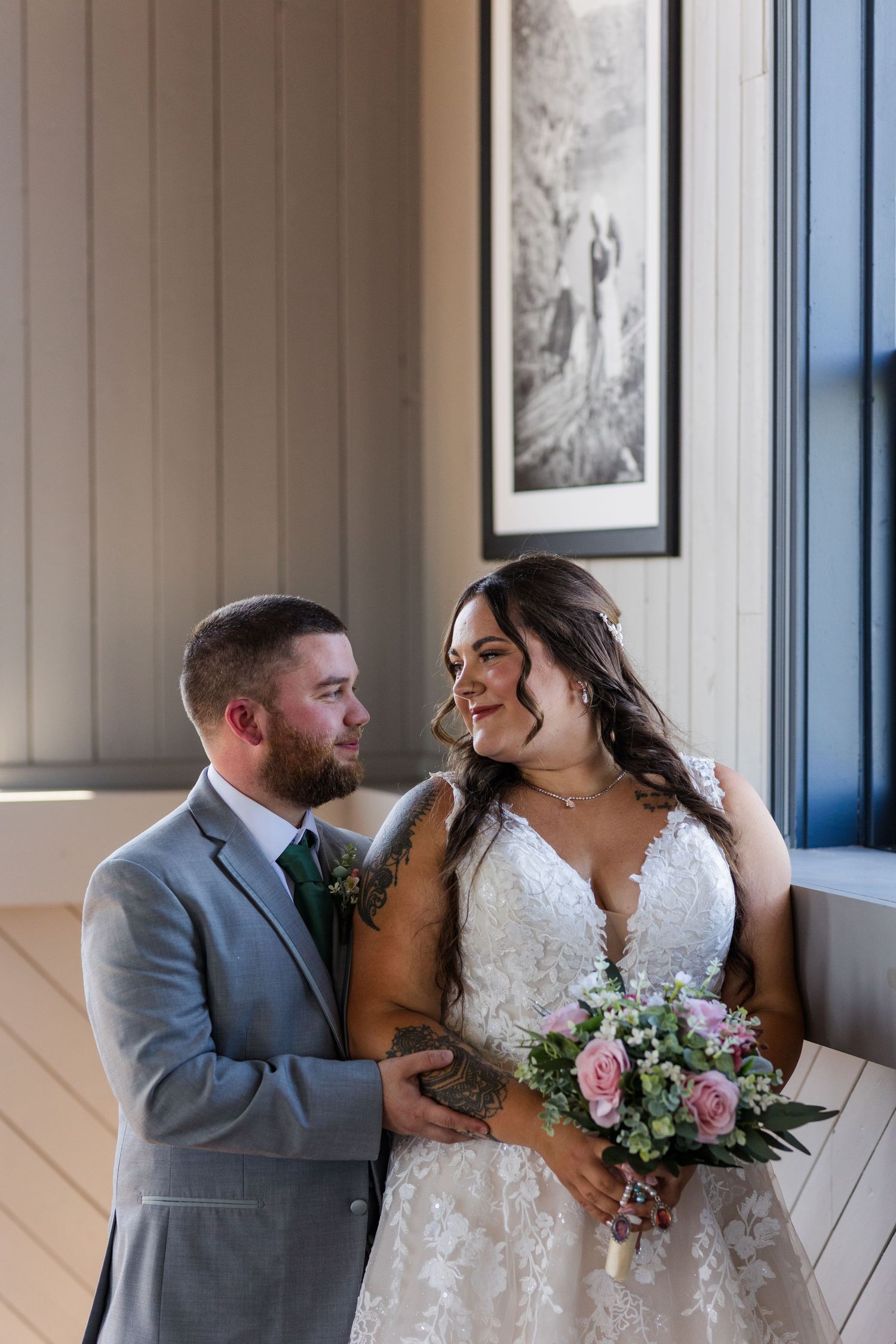 A couple in wedding attire share intimate moments in a series of photos along a light colored hallway.