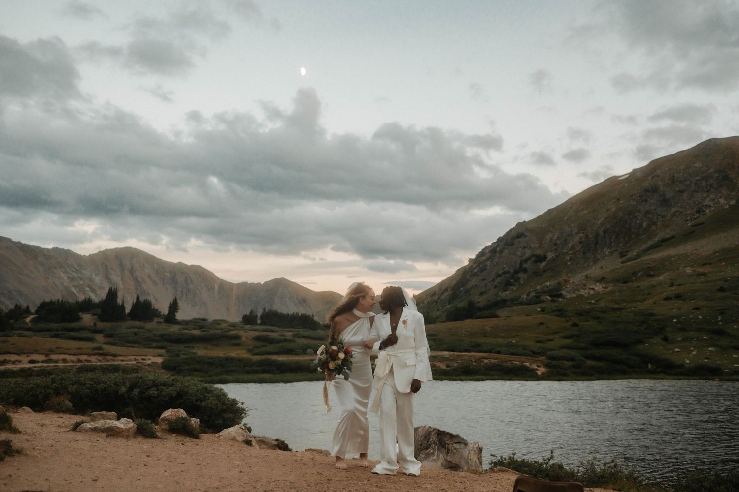 Panoramic sequence of misty mountain landscapes with a lake and dramatic clouds during a wedding ceremony.