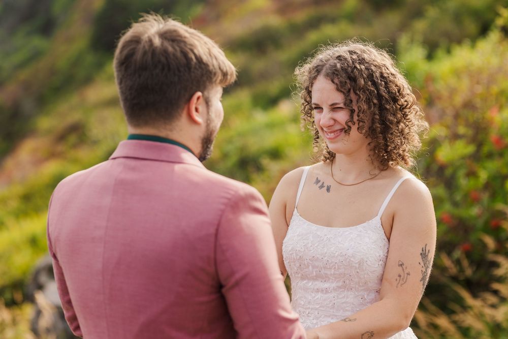 Happy couple walks along a beautiful garden path surrounded by lush greenery and flowers on a sunny autumn day.