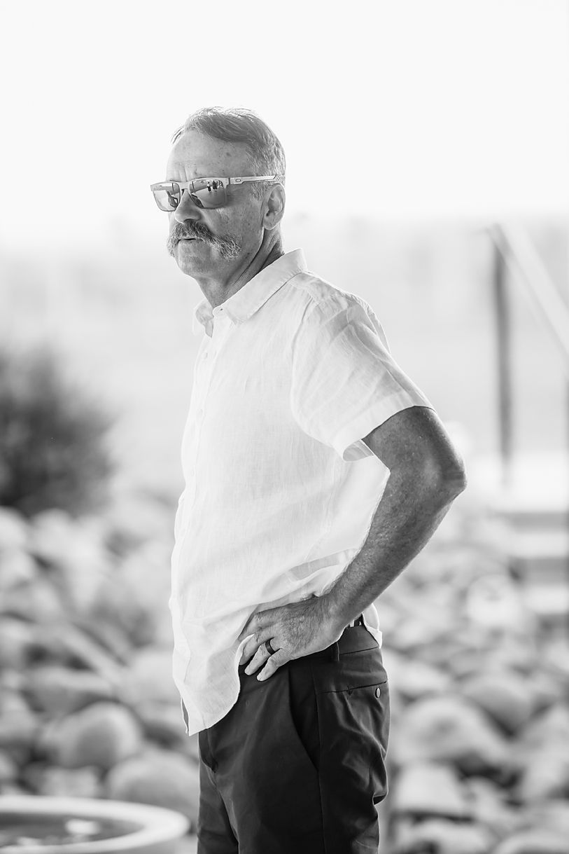 A series of black and white photos showing an elderly person in a white shirt looking thoughtfully to the side.