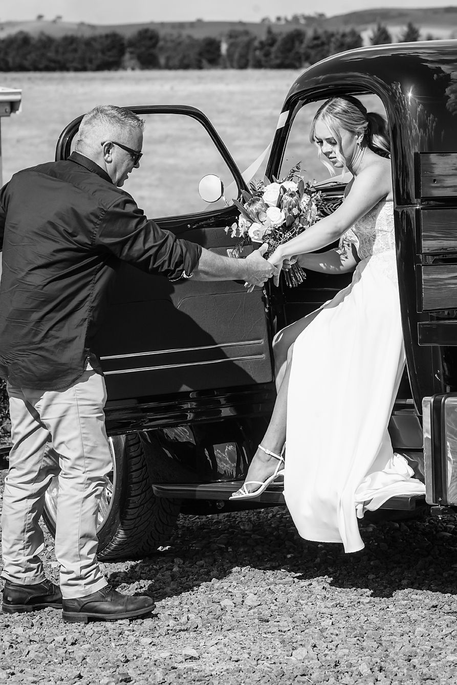 A sequence of black and white photos showing a progression of someone getting out of a vintage car.