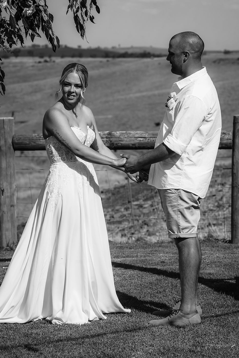 Black and white engagement photos show a couple in white outfits playfully interacting outdoors in a romantic sequence.