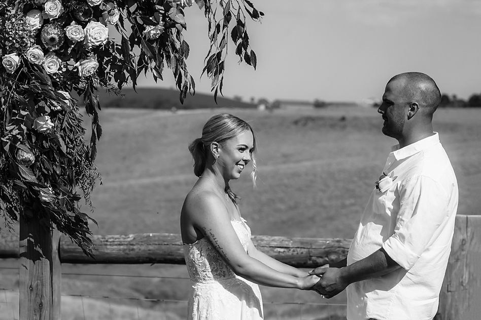A romantic wedding montage showing six candid moments between a couple in an outdoor setting wearing white attire.