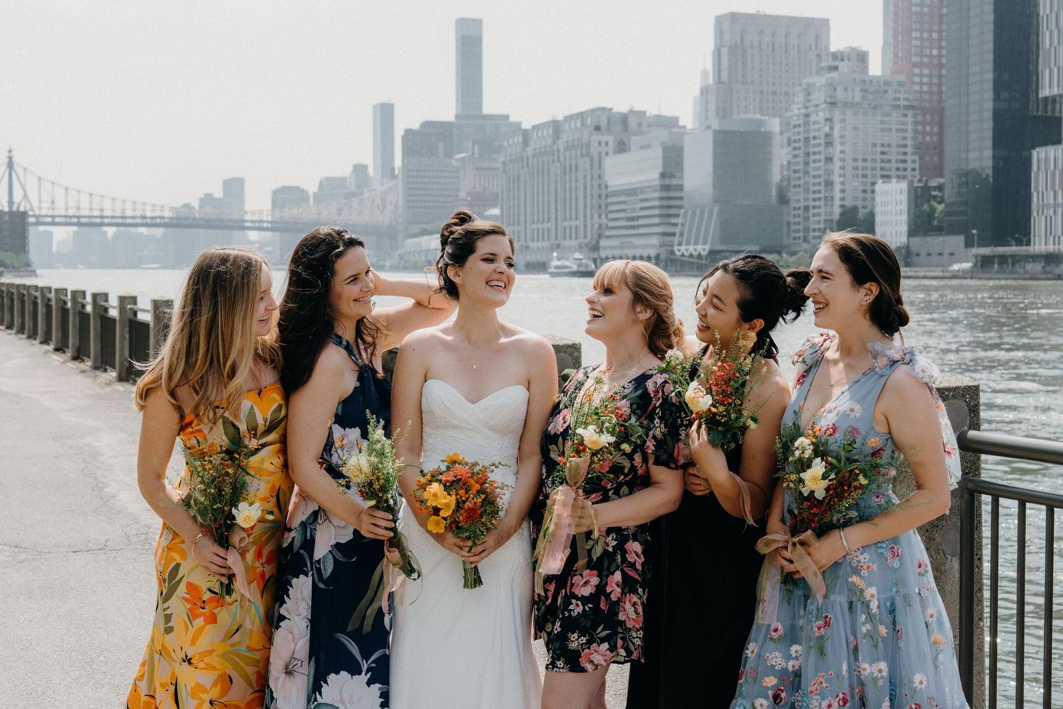 Wedding party in floral dresses laughs together at The Sanctuary Roosevelt Island