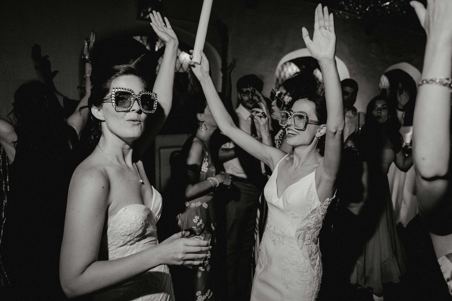 Party goers dance and celebrate at a lively indoor event with festive lighting and raised hands at the Sanctuary Roosevelt Island NYC