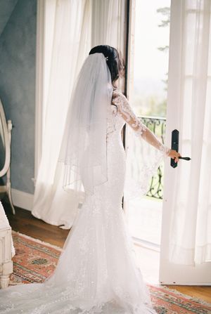 Artistic collage of flowing white wedding dress and veil against bright window.
