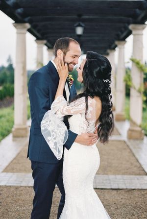 Bride and groom share tender kisses under a columned walkway in sequence of romantic wedding portraits.