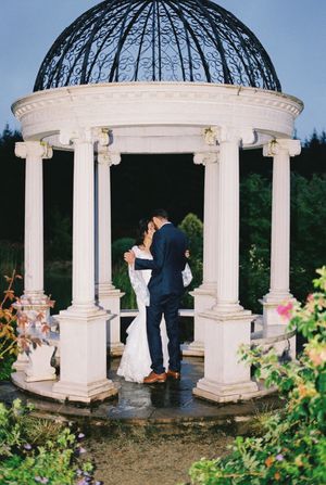 Wedding ceremony sequence under a classical domed gazebo with white columns and garden backdrop.