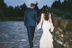 Series of artistic wedding shots showing couple walking along rustic stone wall at dusk.