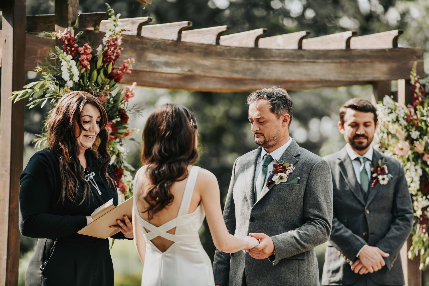 a  bride and groom exchange vows at oak and ivy