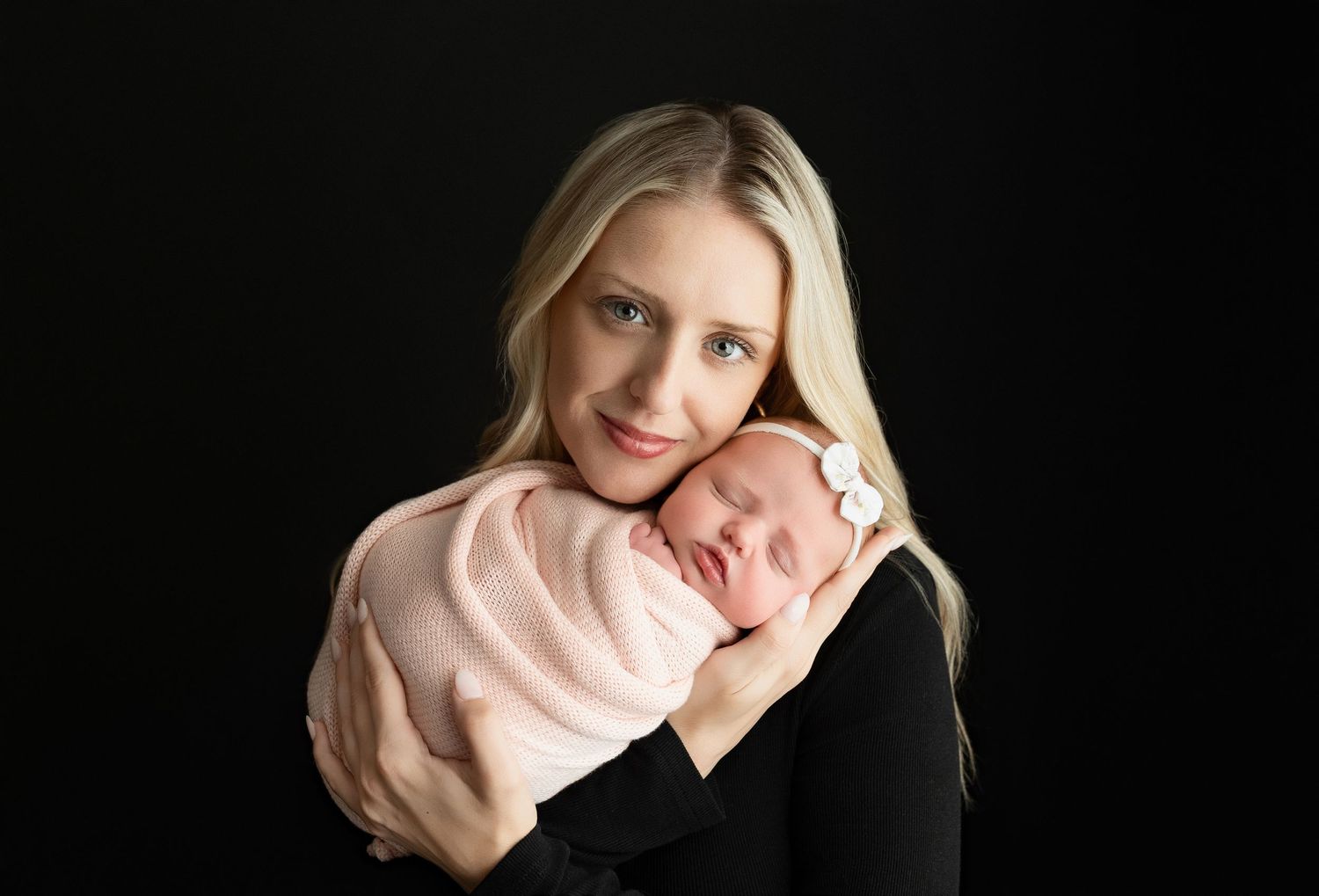 Mom is holding the newborn baby girl very tenderly.  - Greenville SC newborn photographer - Easley SC newborn photographer