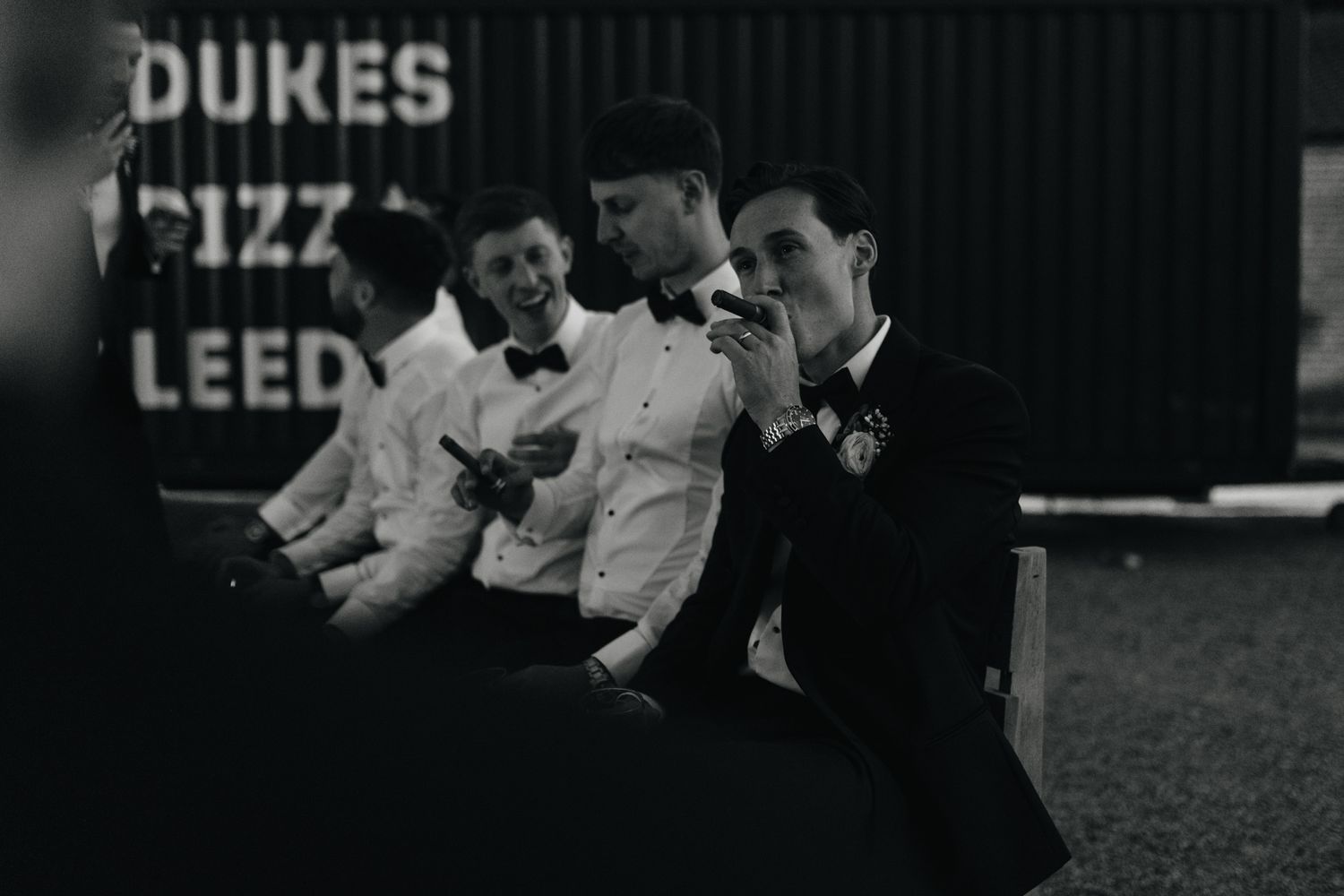 Wedding reception dance floor captured in dramatic black and white lighting.