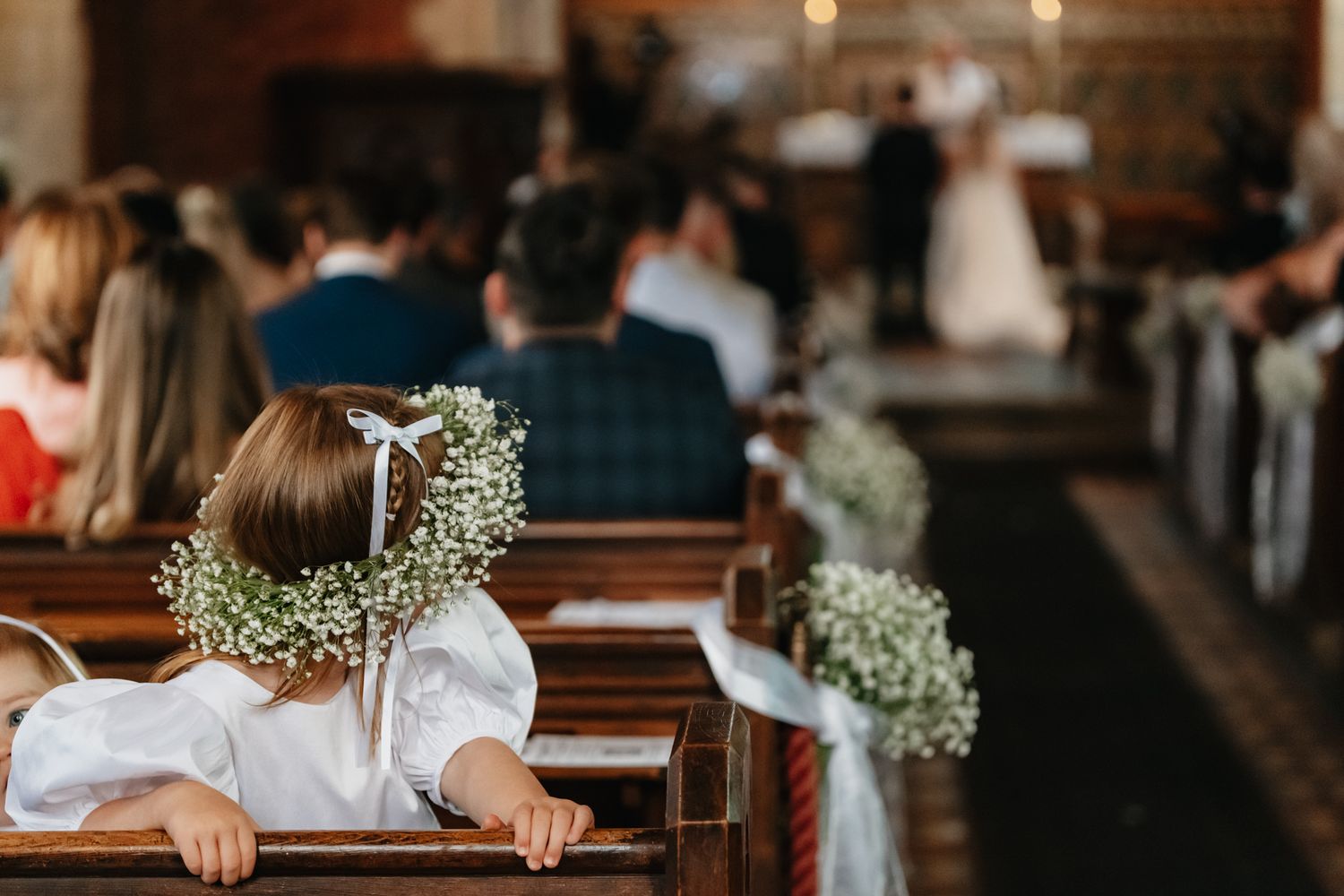 Simple rustic church interior decorated with baby's breath flowers for a wedding ceremony.