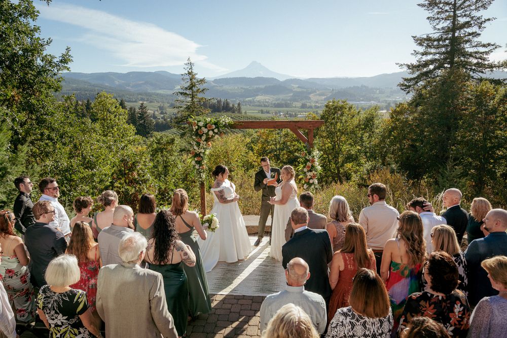 Couple exchanging vows at outdoor ceremony with Mount Hood view – Portland Oregon wedding photographer.