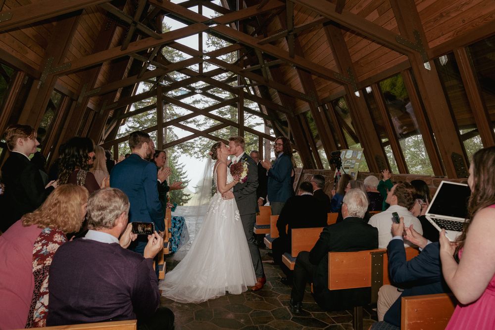 Bride and groom first kiss during indoor chapel ceremony – Portland and Vancouver wedding photography.