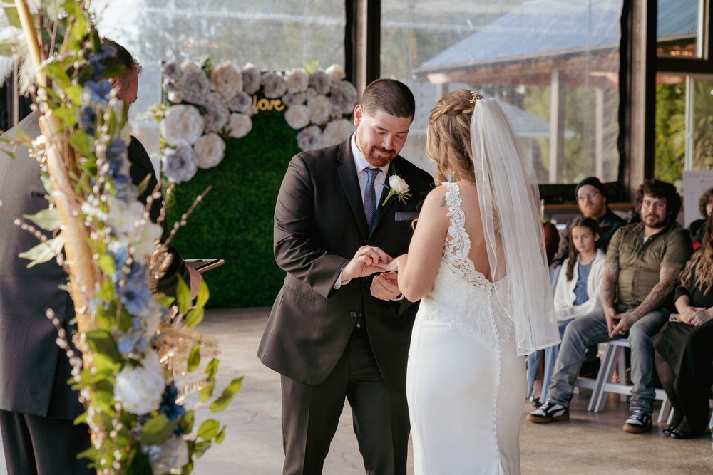 Bride and groom exchanging wedding rings during ceremony – Portland wedding photographer.